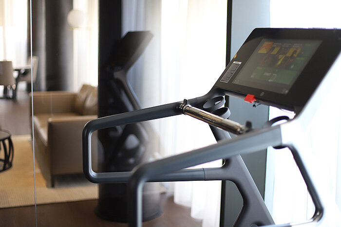 High-tech treadmill in private gym area with mirror wall at Maritim Hotel Plaza Tirana