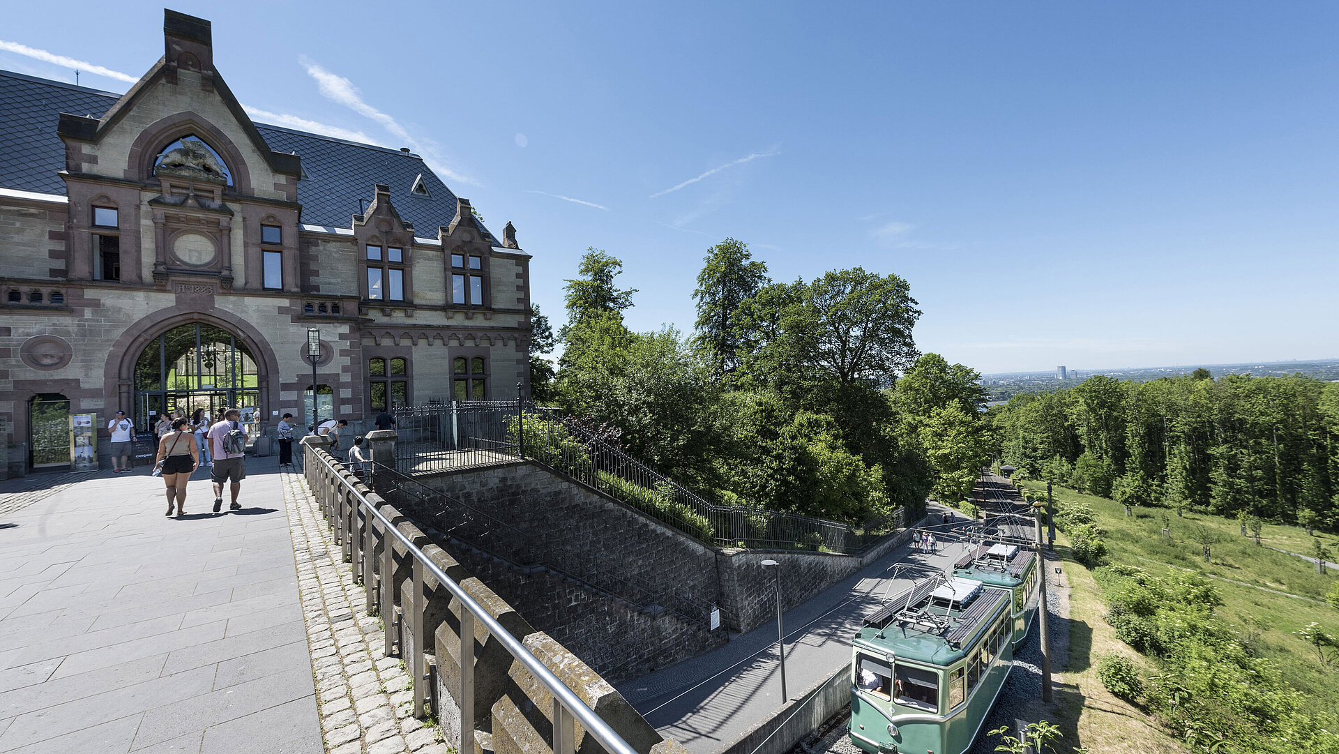The Drachenfelsbahn at the historic station with visitors preparing for the ascent.