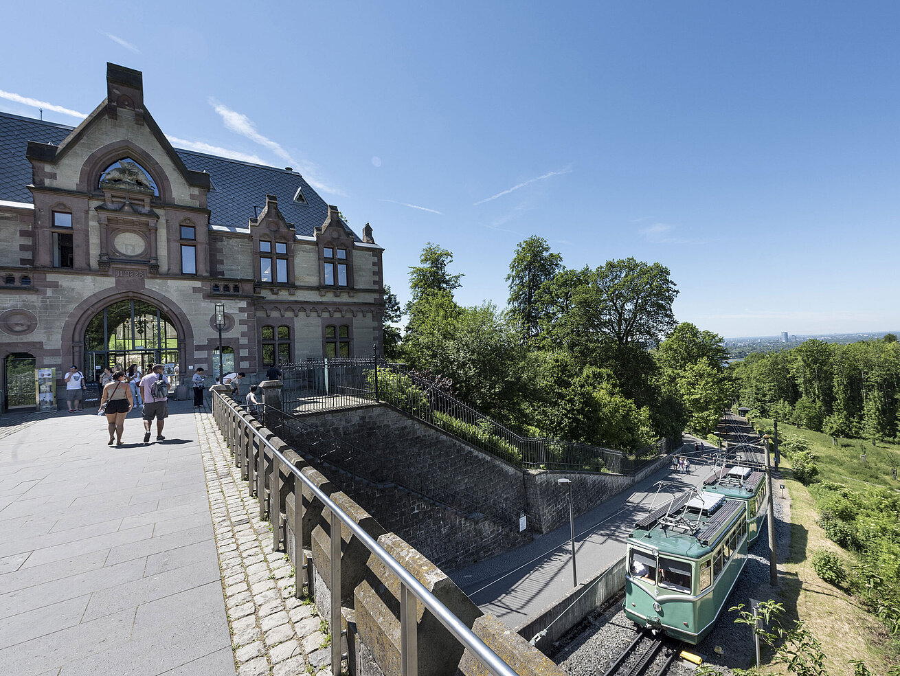 Castle Drachenburg The Drachenfelsbahn at the historic station with visitors preparing for the ascent.