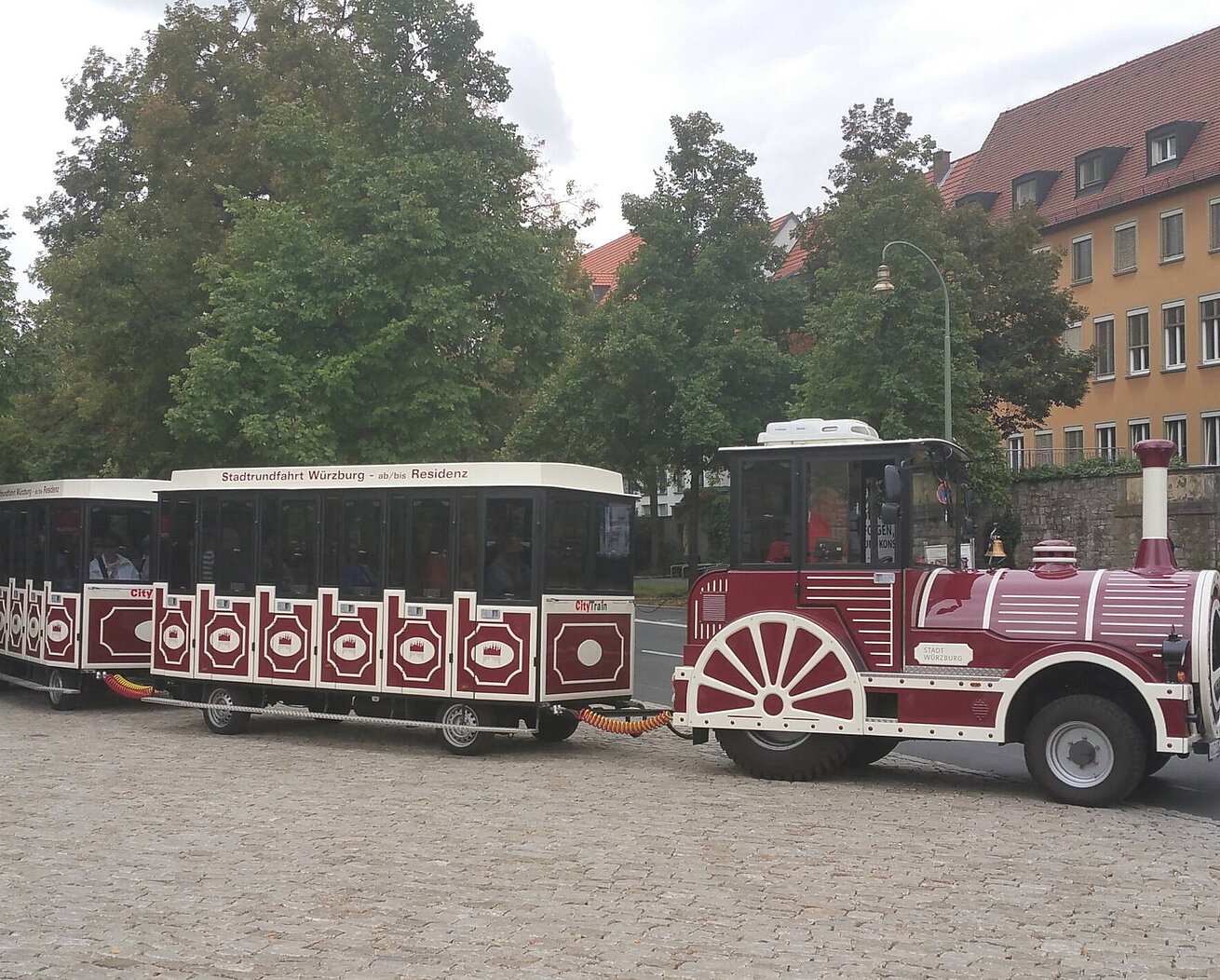 Trenino turistico Würzburg davanti a scenario storico