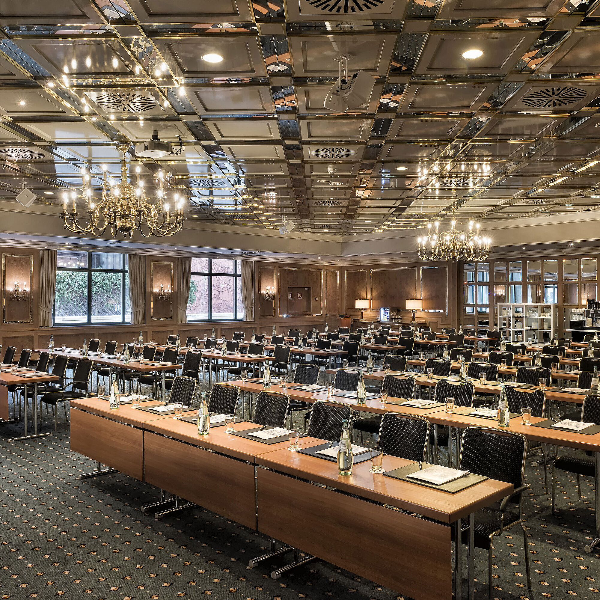Conference room with full row seating, daylight and chandeliers at Maritim Hotel Stuttgart
