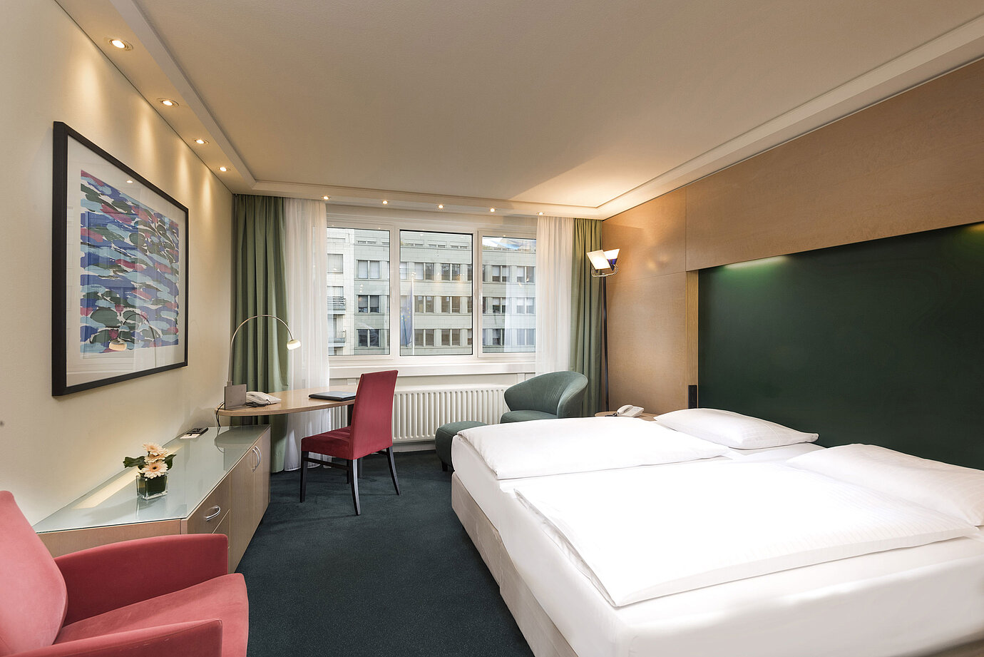 Classic room at Maritim proArte Hotel Berlin with double bed, desk, and view of surrounding buildings.