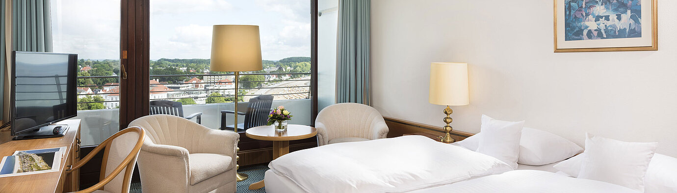 Comfort room  Bright double room at Maritim Hotel Travemünde with balcony and view over rooftops and water