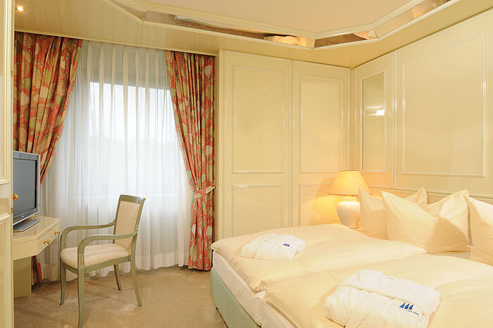 Bright Suite at Maritim Hotel Bremen with elegant bed, seating area, and soft lighting for a comfortable stay.