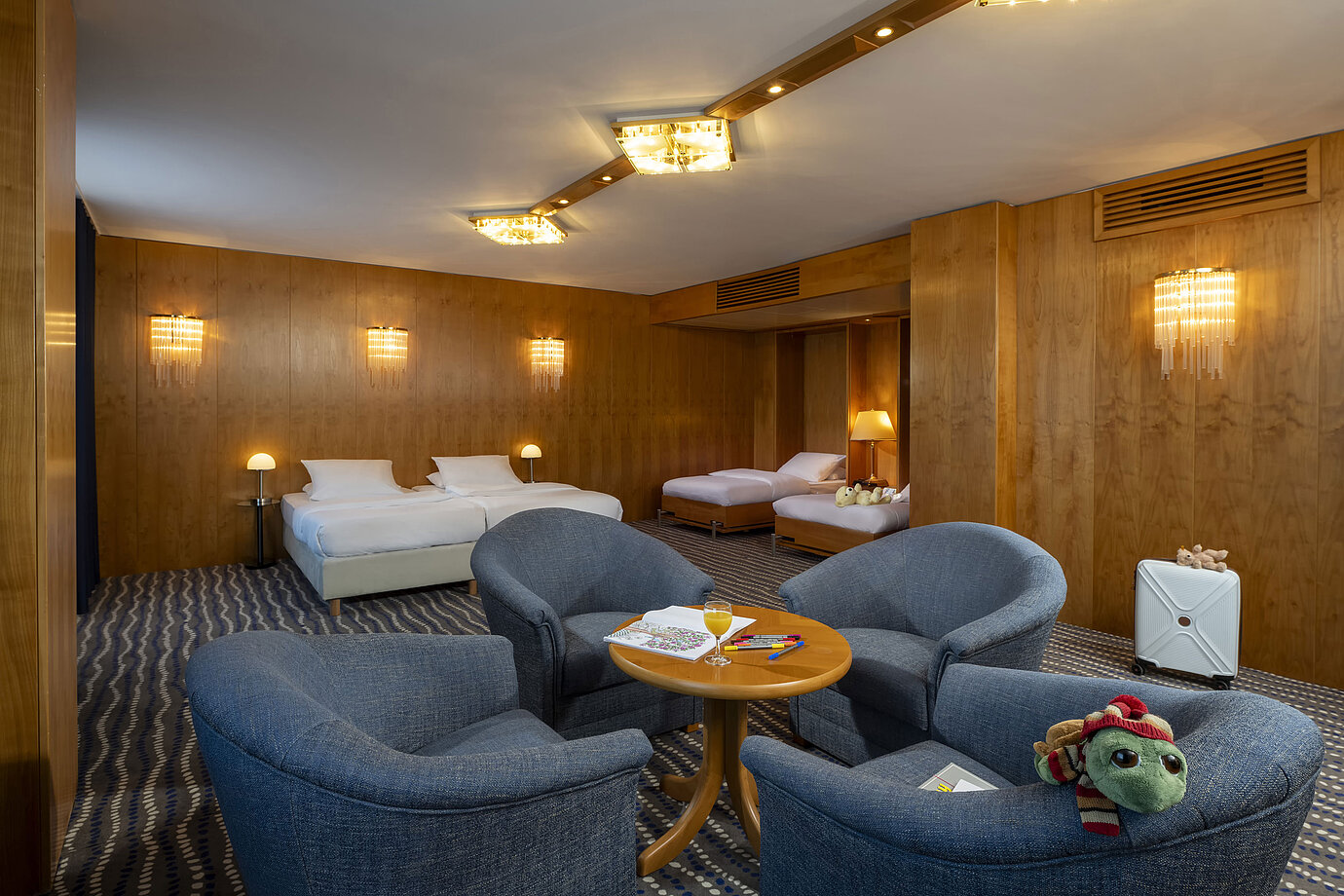 Spacious Superior Family Room at the Maritim Hotel Magdeburg with two double beds, seating area, and child-friendly details.