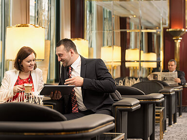 Lounge Two business guests chatting over coffee in the lounge at Maritim Hotel Stuttgart