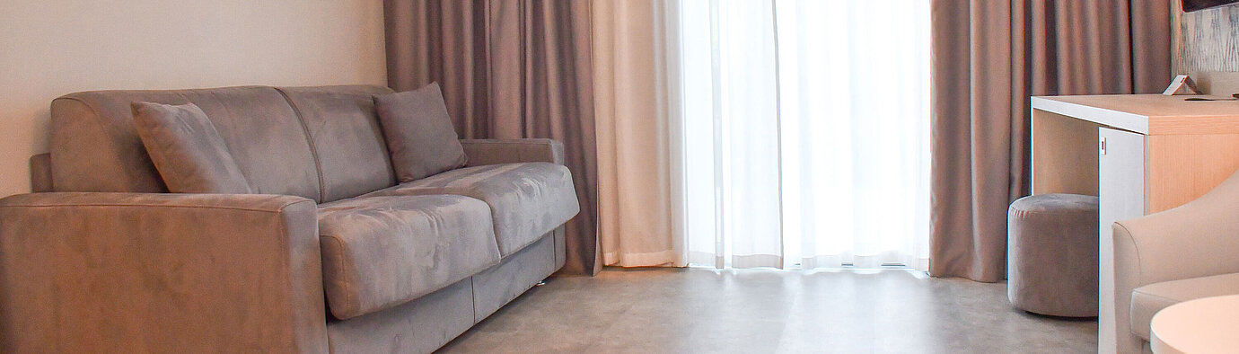 Comfortable sofa bed in the bright room of Maritim Resort Cala