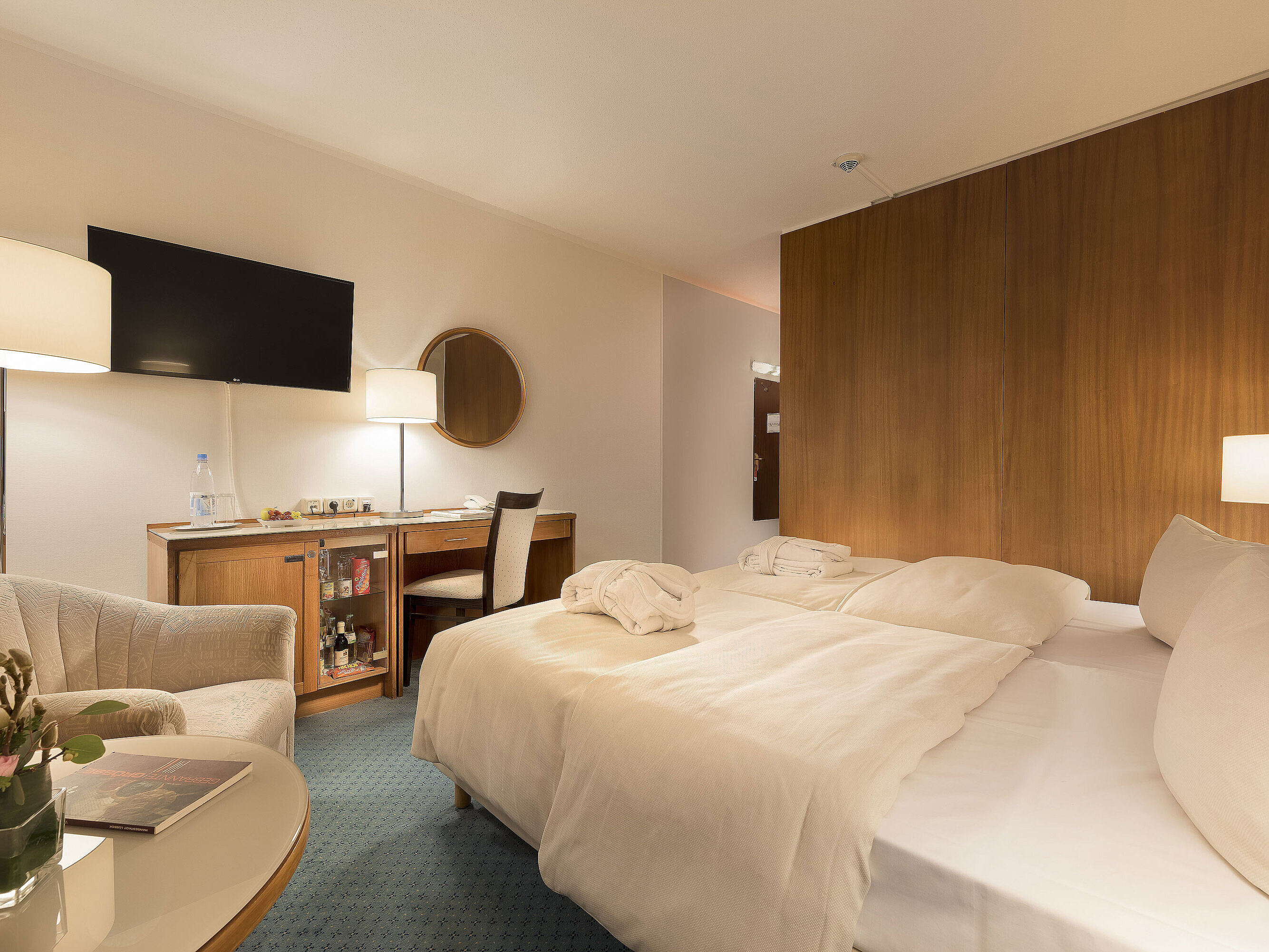 Classic room at Maritim Seehotel Timmendorfer Strand with twin beds, minibar, desk, TV, and seating area.