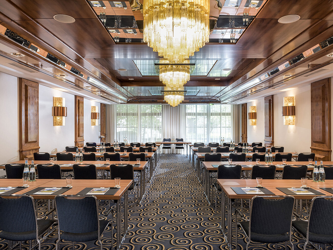Salon Petersberg Stylish meeting room with large chandeliers, natural light, and modern seating at Maritim Hotel Königswinter.