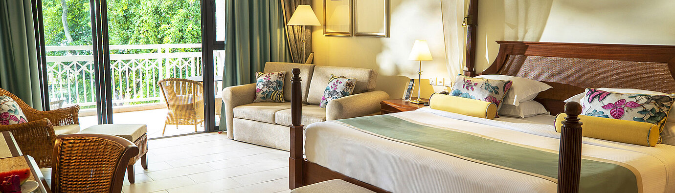 Deluxe plus room Spacious hotel room with four-poster bed, sofa, balcony and green views