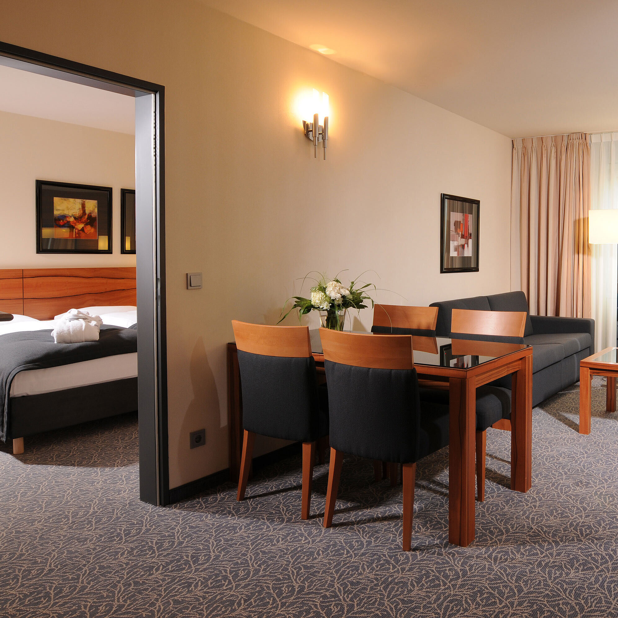 Senior suite Spacious suite with living room, dining table and separate bedroom at Maritim Hotel Munich
