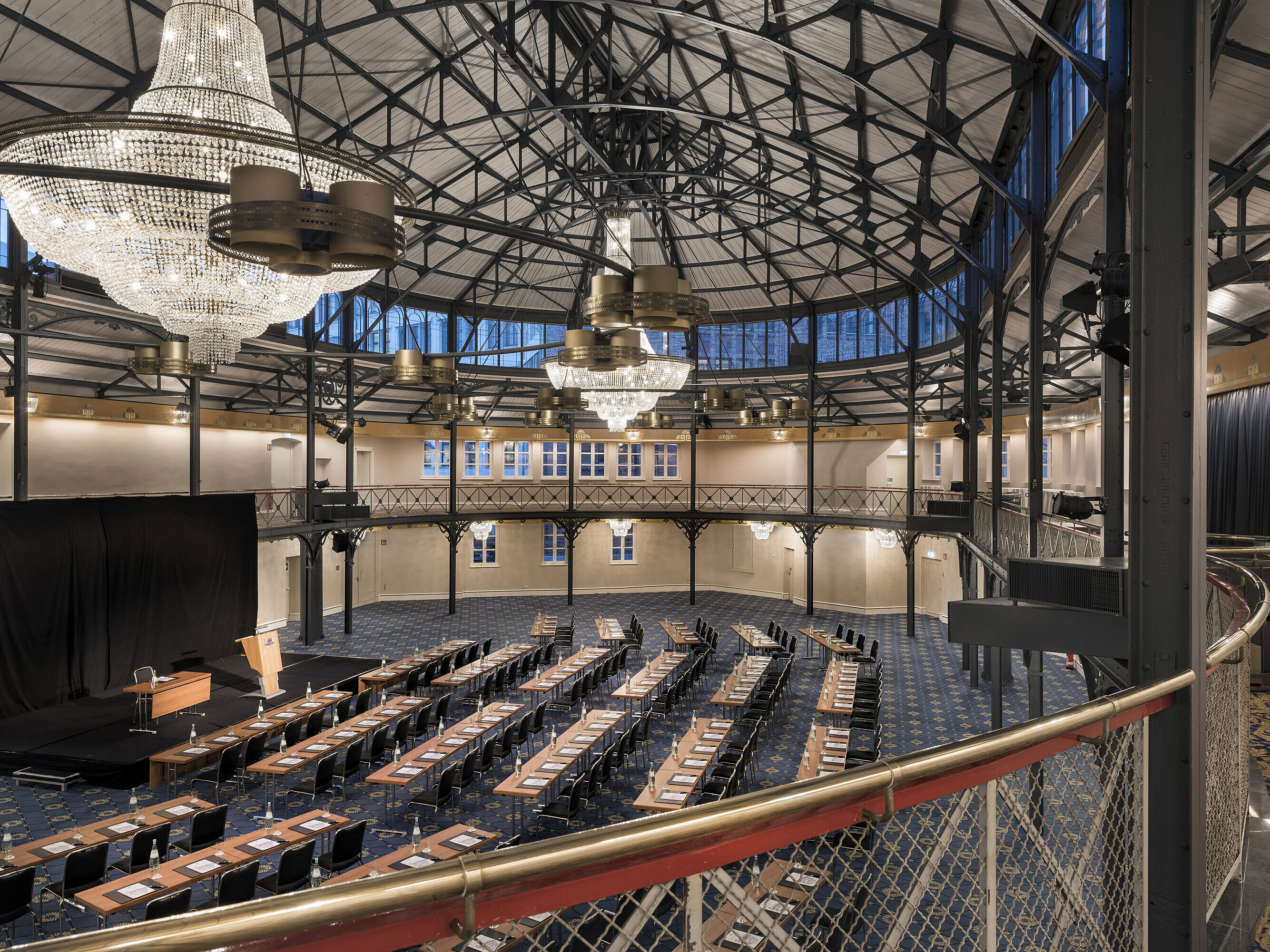 Historic riding hall with stage, chandeliers and seating rows at Maritim Hotel Stuttgart