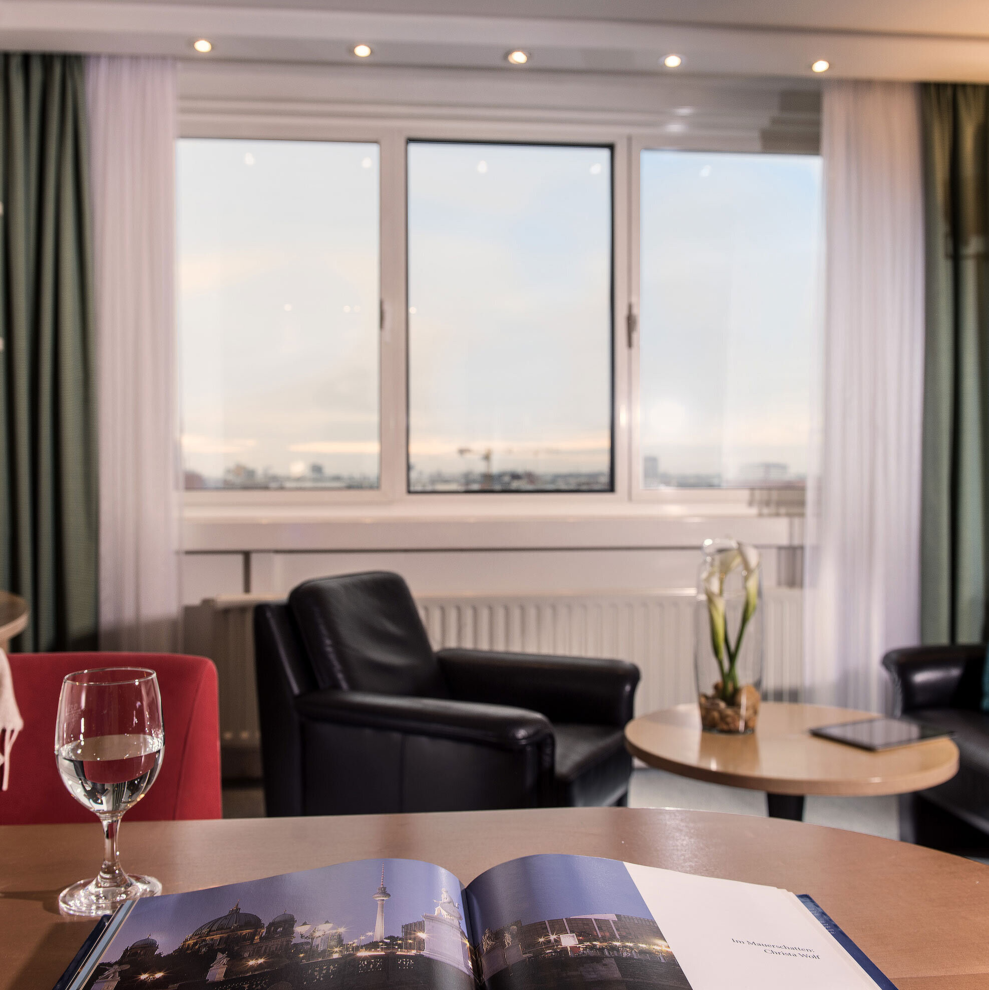 Family suite Junior suite at Maritim proArte Hotel Berlin with seating area, city view, and elegant design elements.