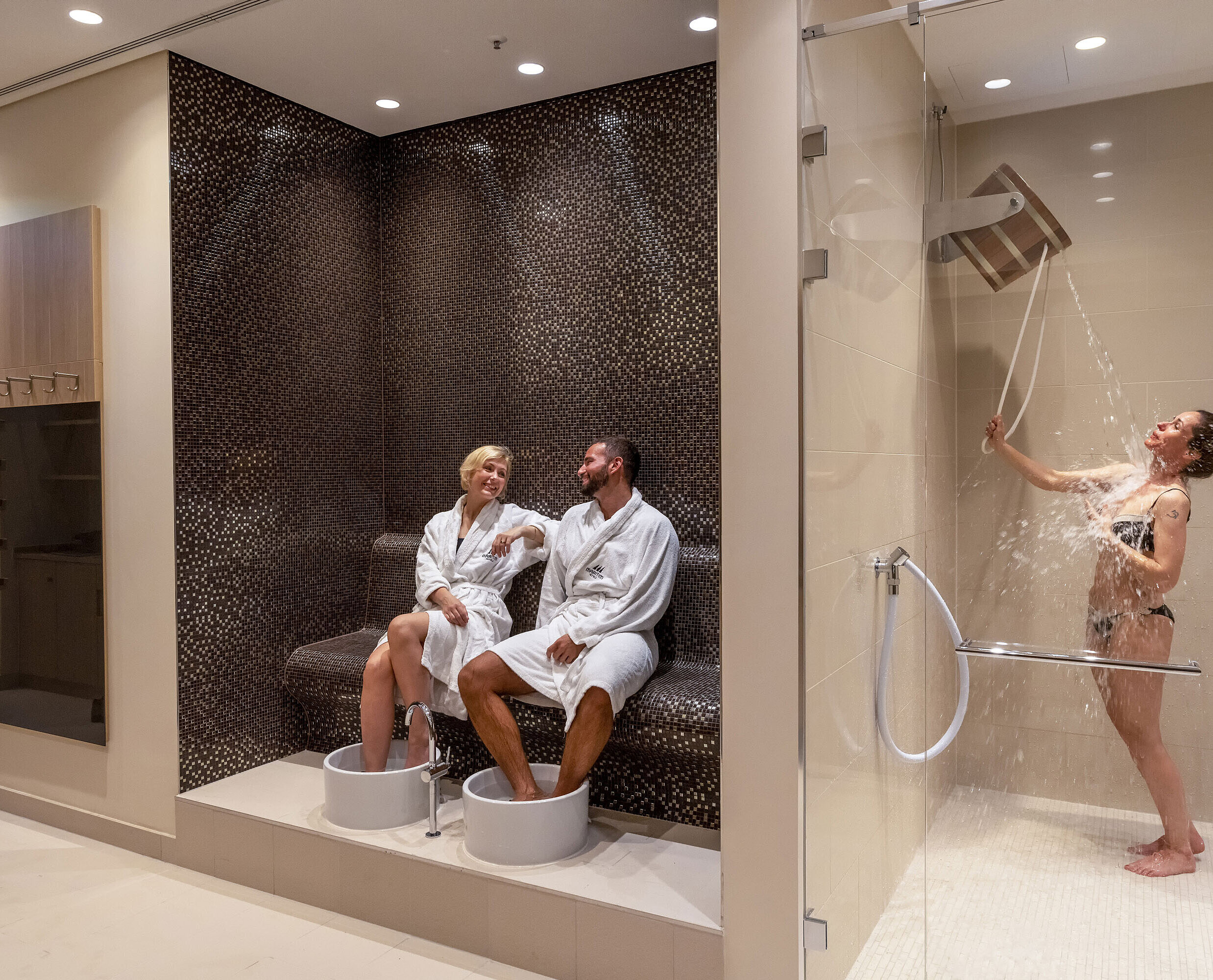 Wellness area at Maritim Hotel Ingolstadt with foot baths, experience shower, and relaxing atmosphere.