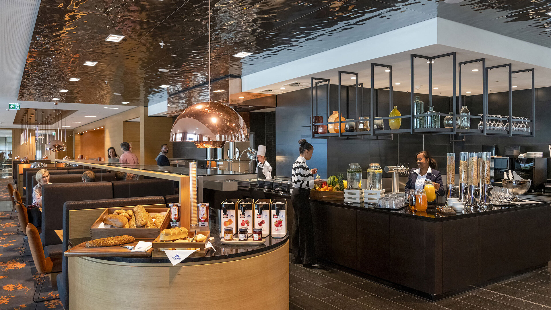 Extensive breakfast buffet at Maritim Hotel Ingolstadt with fresh pastries, fruit, and juices.