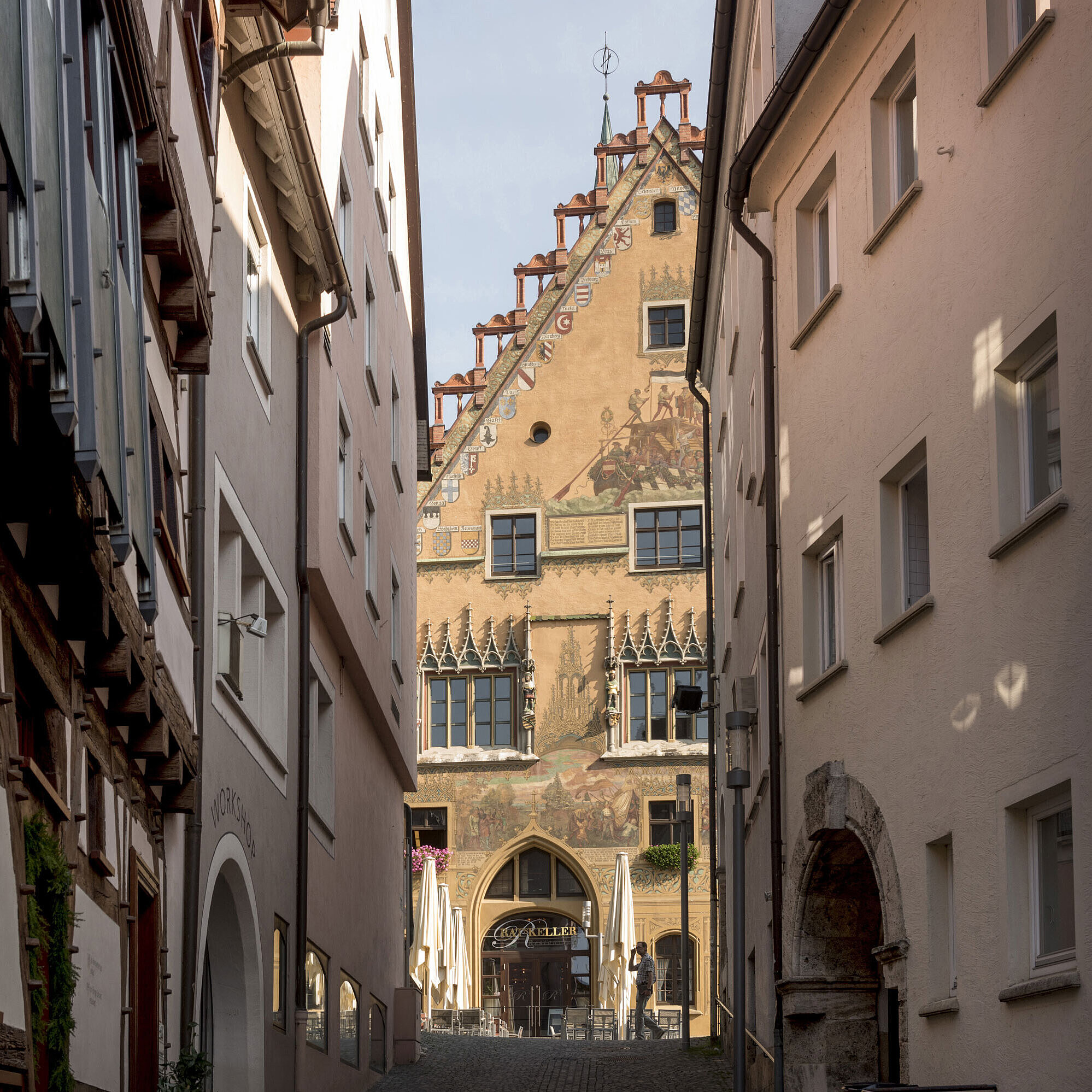 Historic alley with view of colourful Ulm Town Hall in the old town