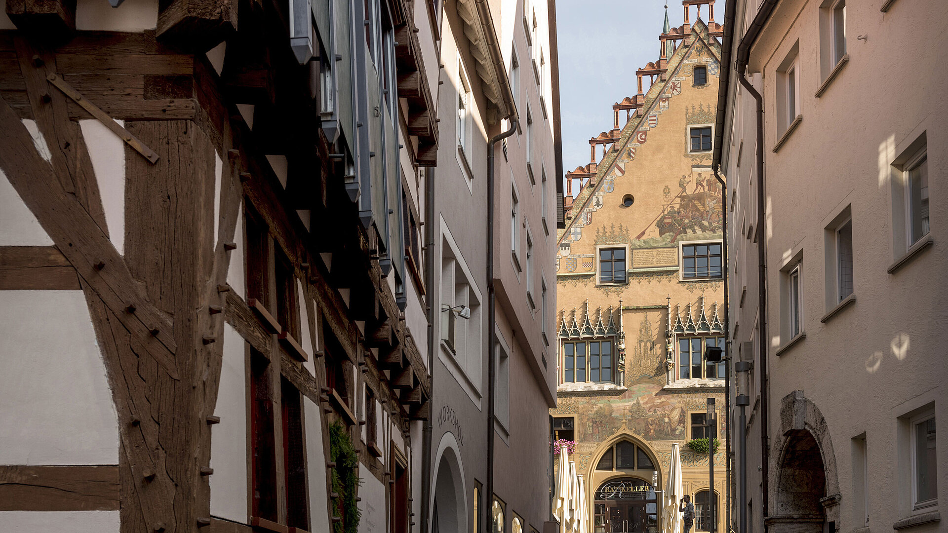 Historic alley with view of colourful Ulm Town Hall in the old town