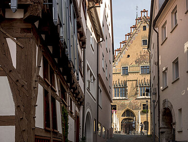 Historic alley with view of colourful Ulm Town Hall in the old town