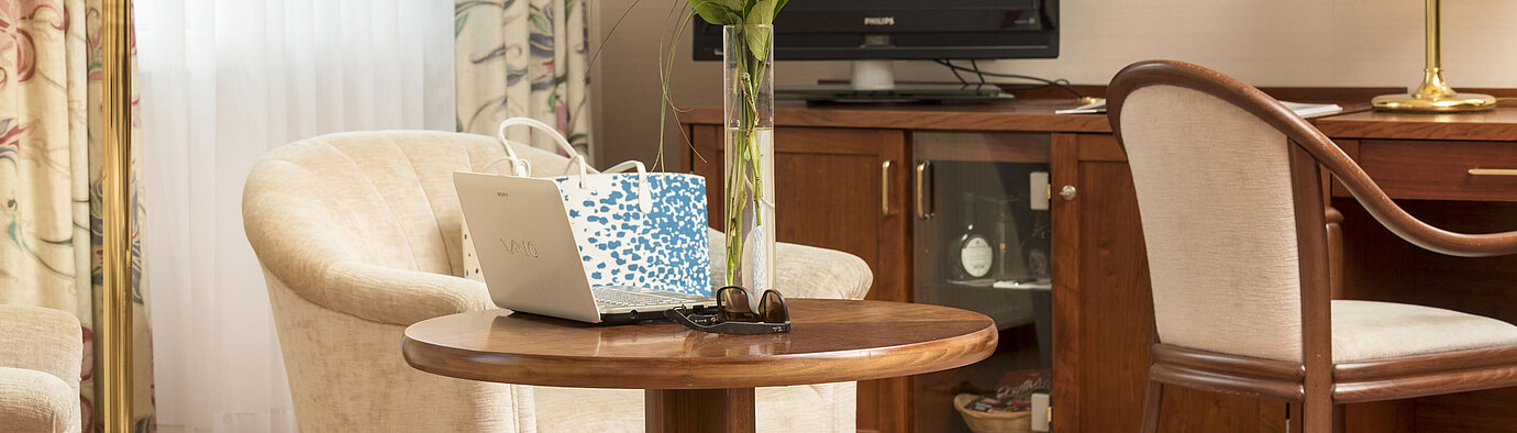 Detail of the hotel room  Cosy seating area with roses, laptop and TV in the room of Maritim Hotel Bad Wildungen