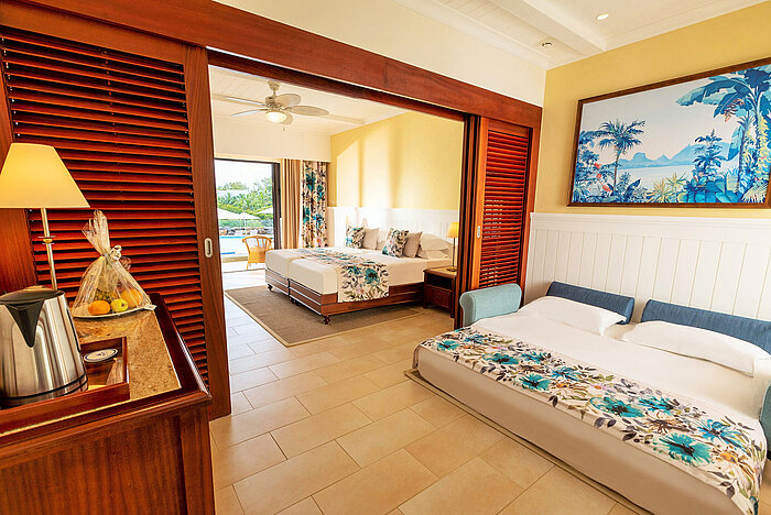 Junior Suite A spacious family room with two beds and direct access to the pool