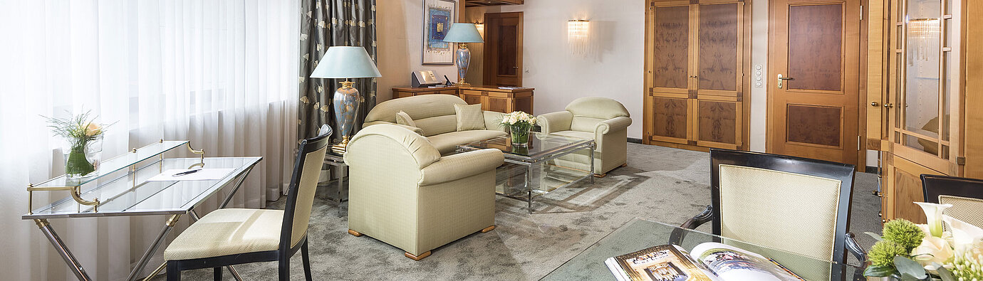 Luxury suite  Spacious suite with elegant furnishings, glass table and cosy lounge at Maritim Hotel Magdeburg