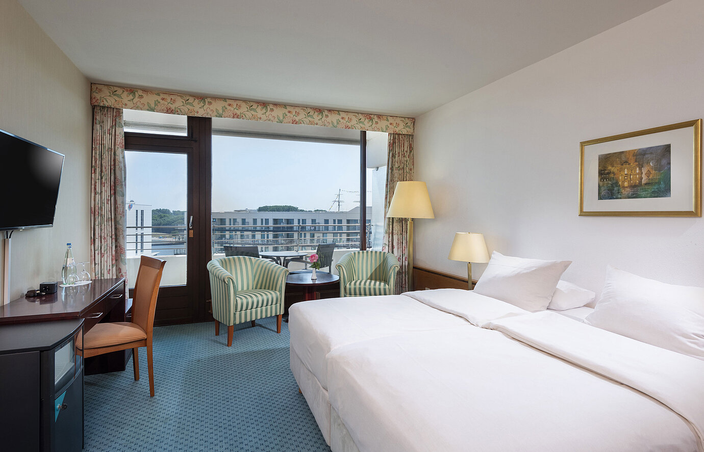 Double room at Maritim Hotel Travemünde with seating area and city view