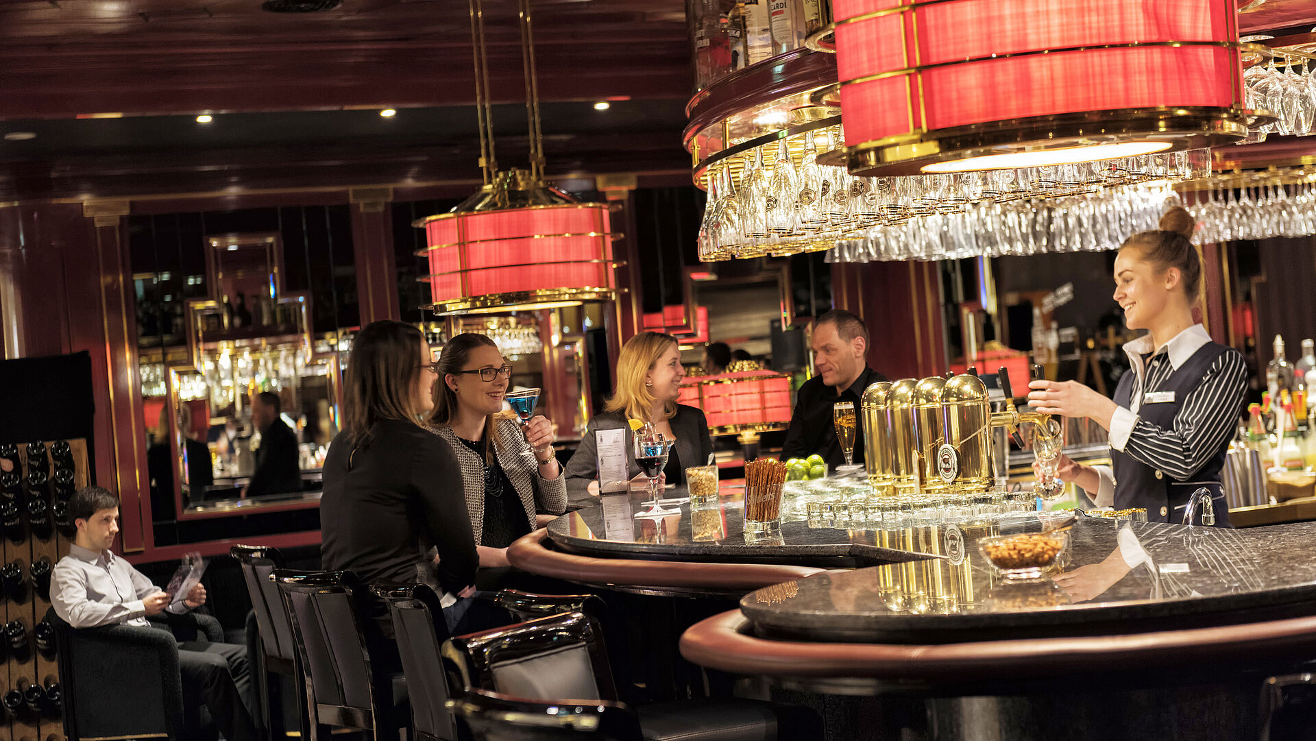 Guests enjoy cocktails and conversation in a stylish setting at the Maritim Hotel Ulm bar