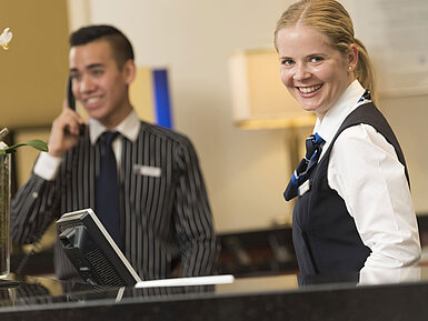 Smiling staff at the reception of Maritim Hotel Bad Homburg offer a warm welcome.
