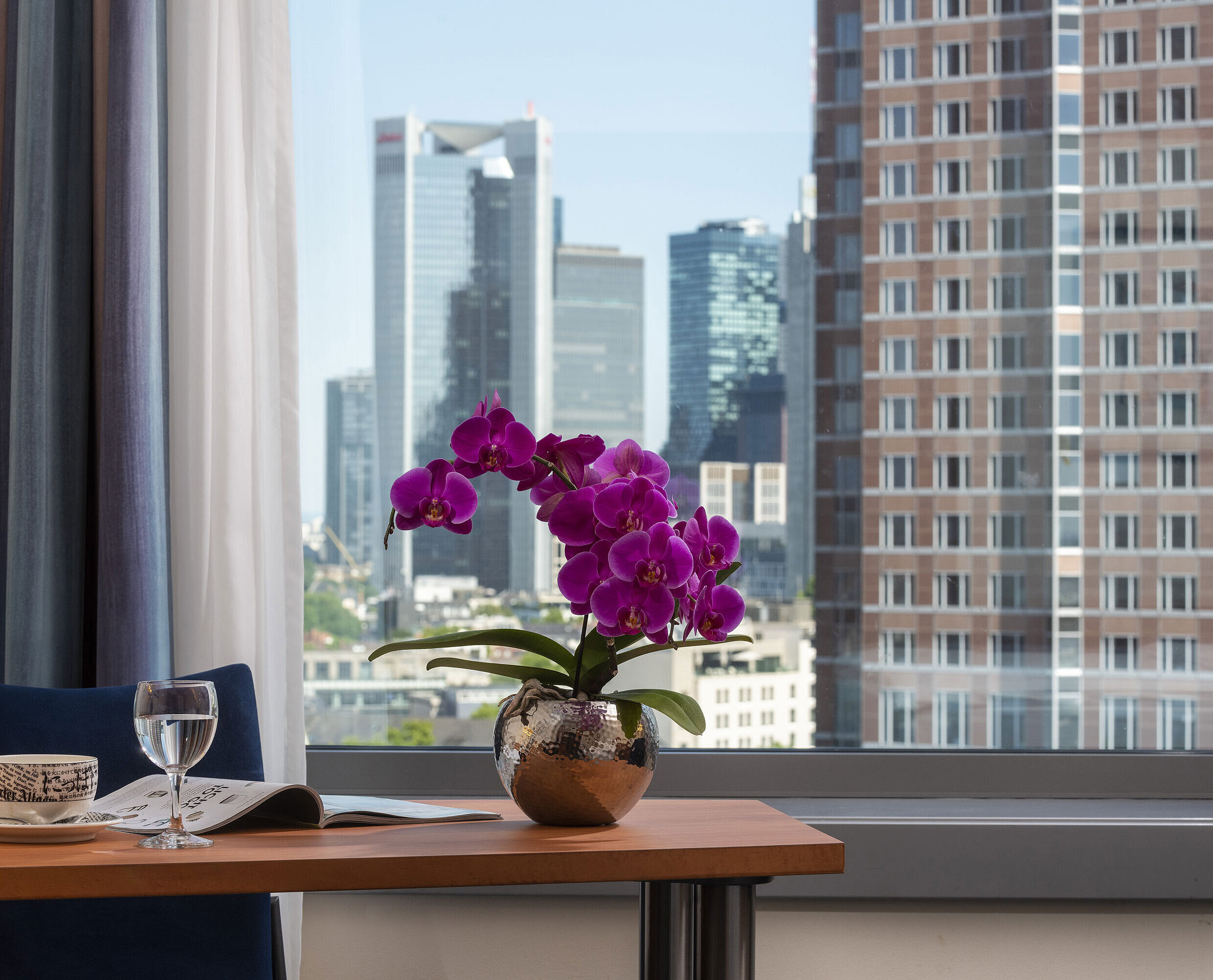 Superior Skyline room View from the room at Maritim Hotel Frankfurt with skyline panorama, desk, and elegant orchid.