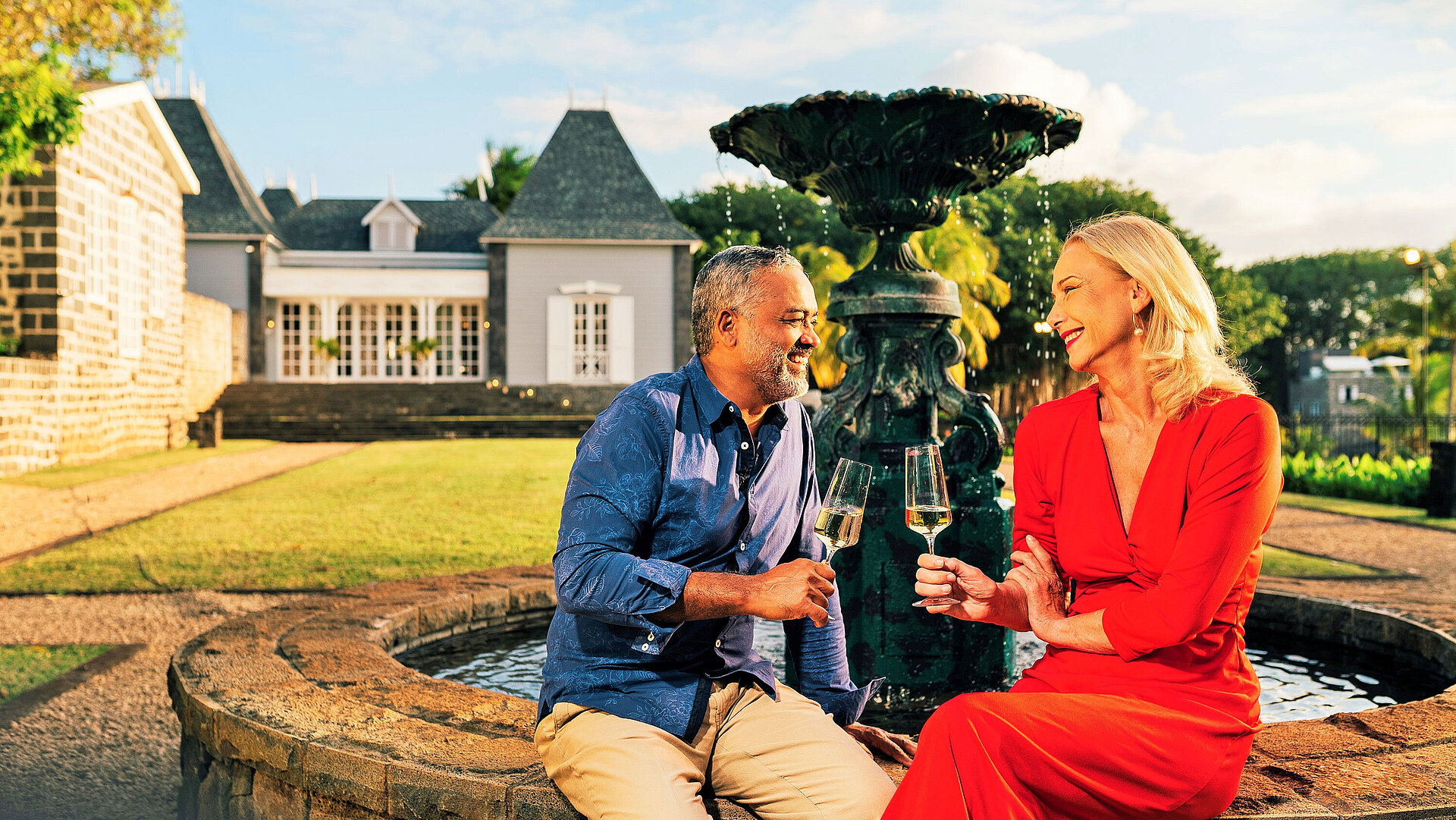 English Garden Couple enjoying a glass of wine by a fountain in a landscaped garden