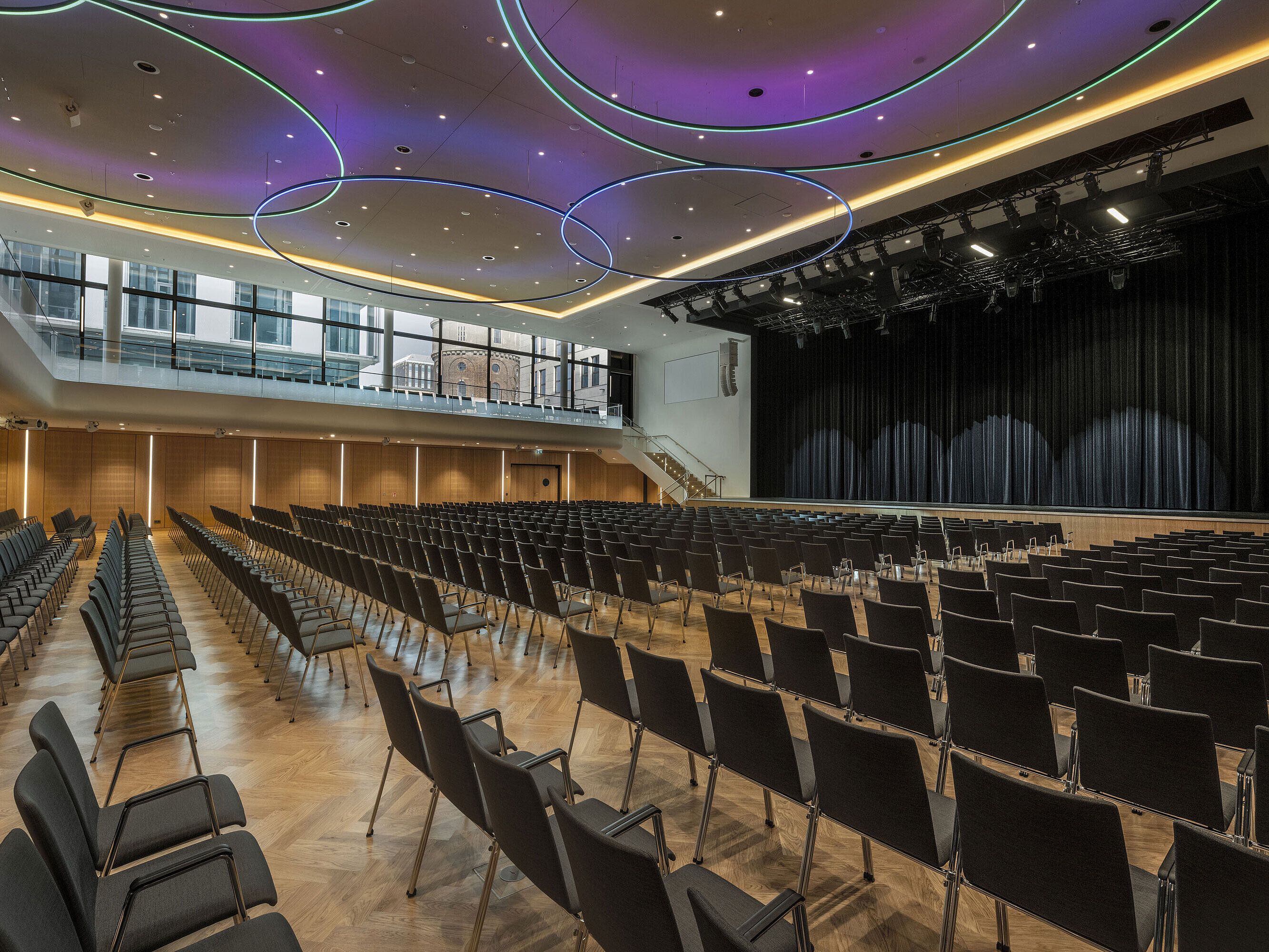 Modern event hall at Maritim Hotel Ingolstadt with stylish LED lighting and large stage.