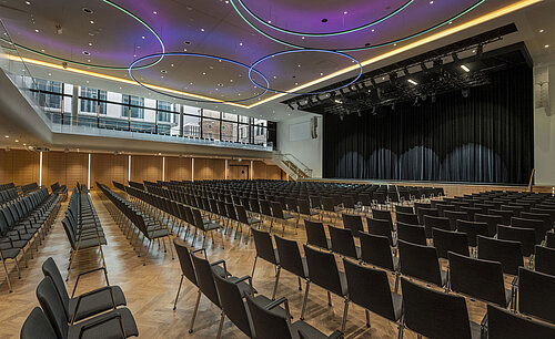 Modern event hall at Maritim Hotel Ingolstadt with stylish LED lighting and large stage.