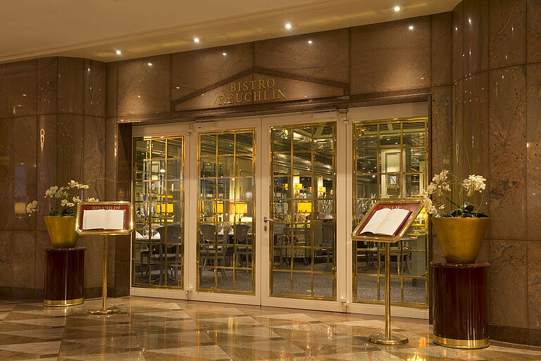 Elegant entrance of Bistro Reuchlin at Maritim Hotel Stuttgart with golden accents
