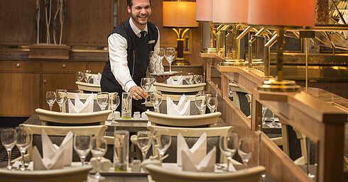 Waiter with tray of glasses in the restaurant at Maritim Hotel Stuttgart, friendly and welcoming