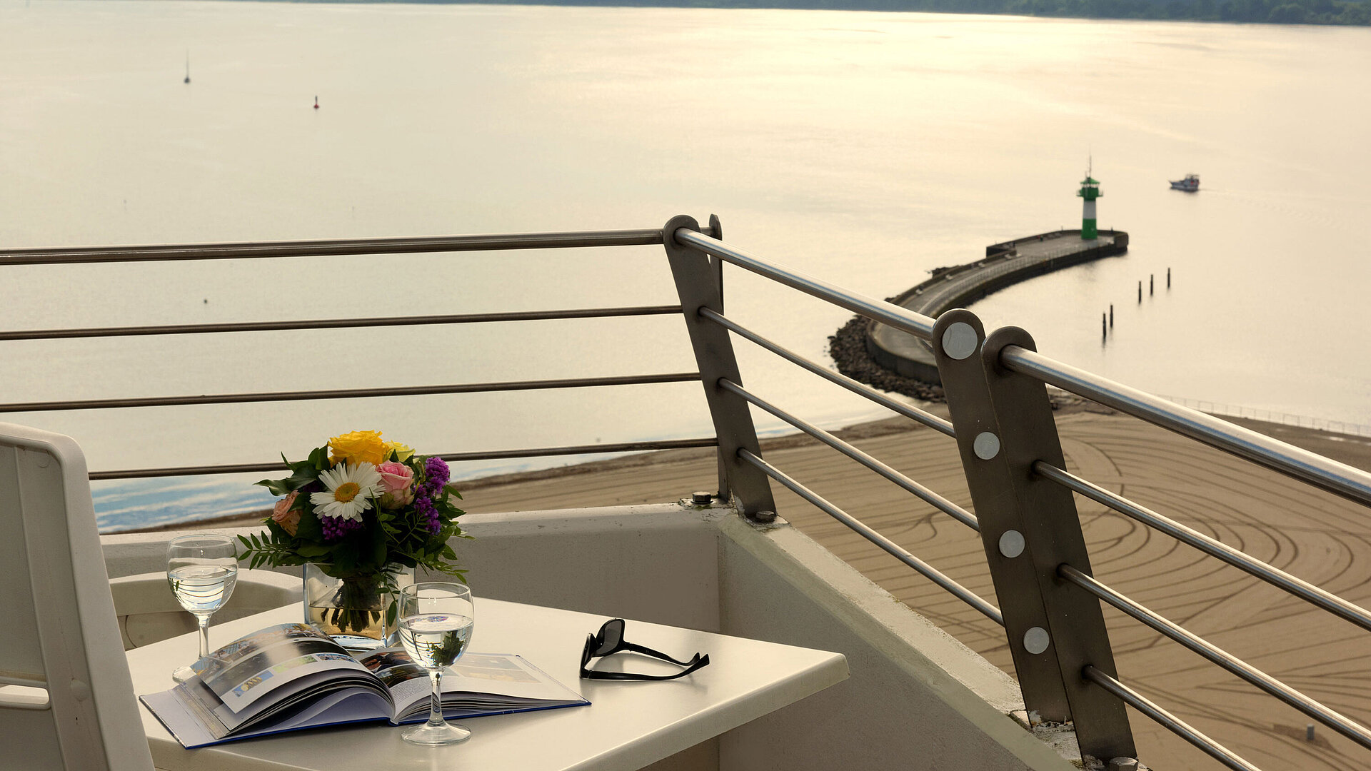 Balcony with sea view at Maritim Hotel Travemünde, table set with wine and flowers