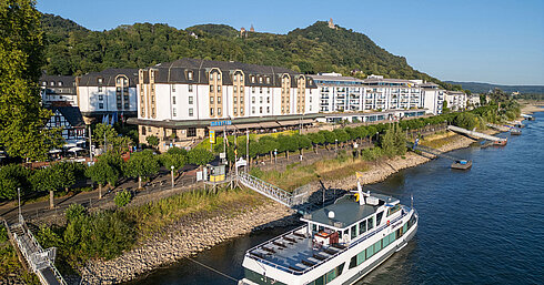 Exterior view Aerial view of Maritim Hotel Königswinter on the Rhine promenade with a sightseeing boat on the River Rhine.