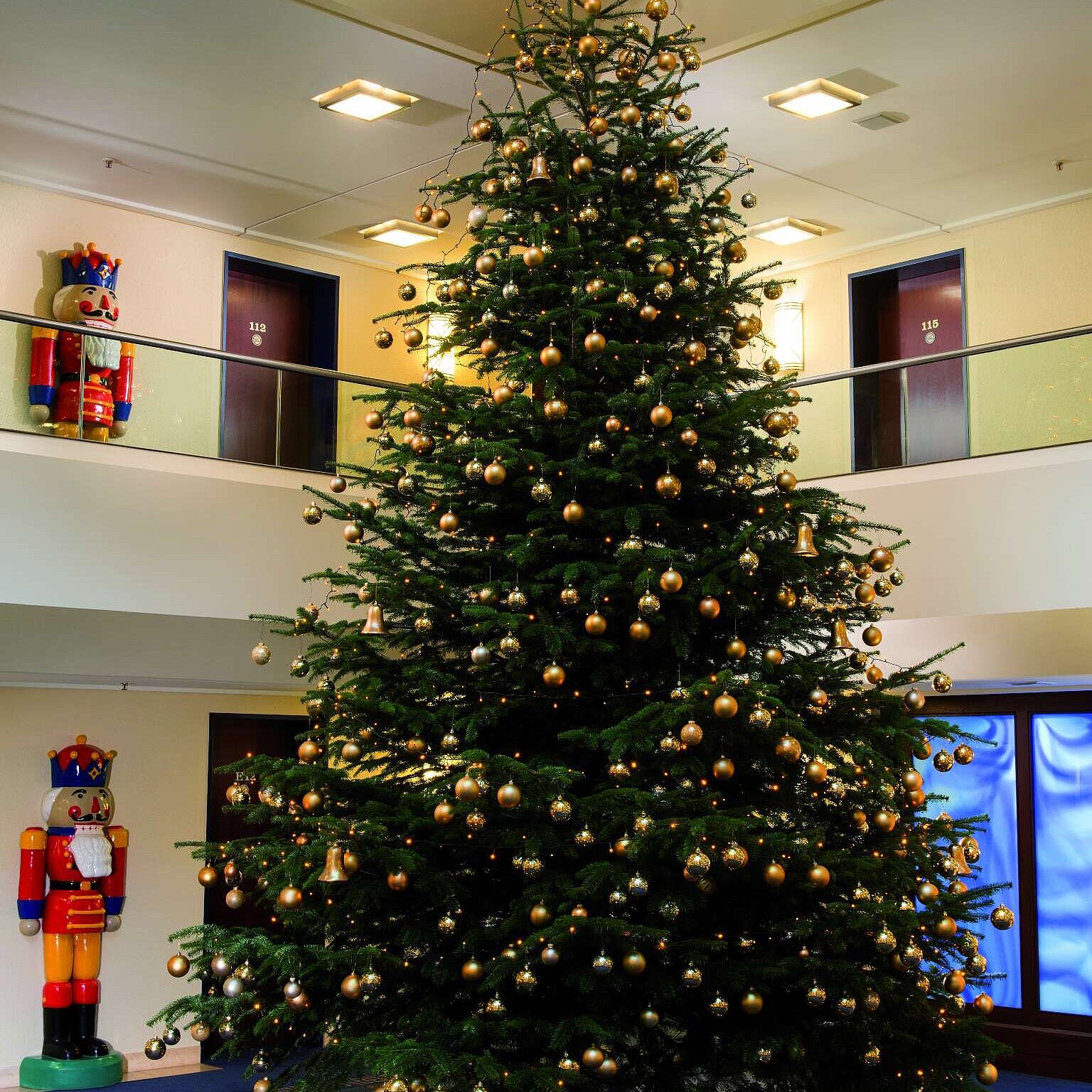 Festive Christmas tree in the lobby with gifts.