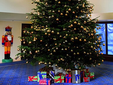 Festive Christmas tree in the lobby with gifts.
