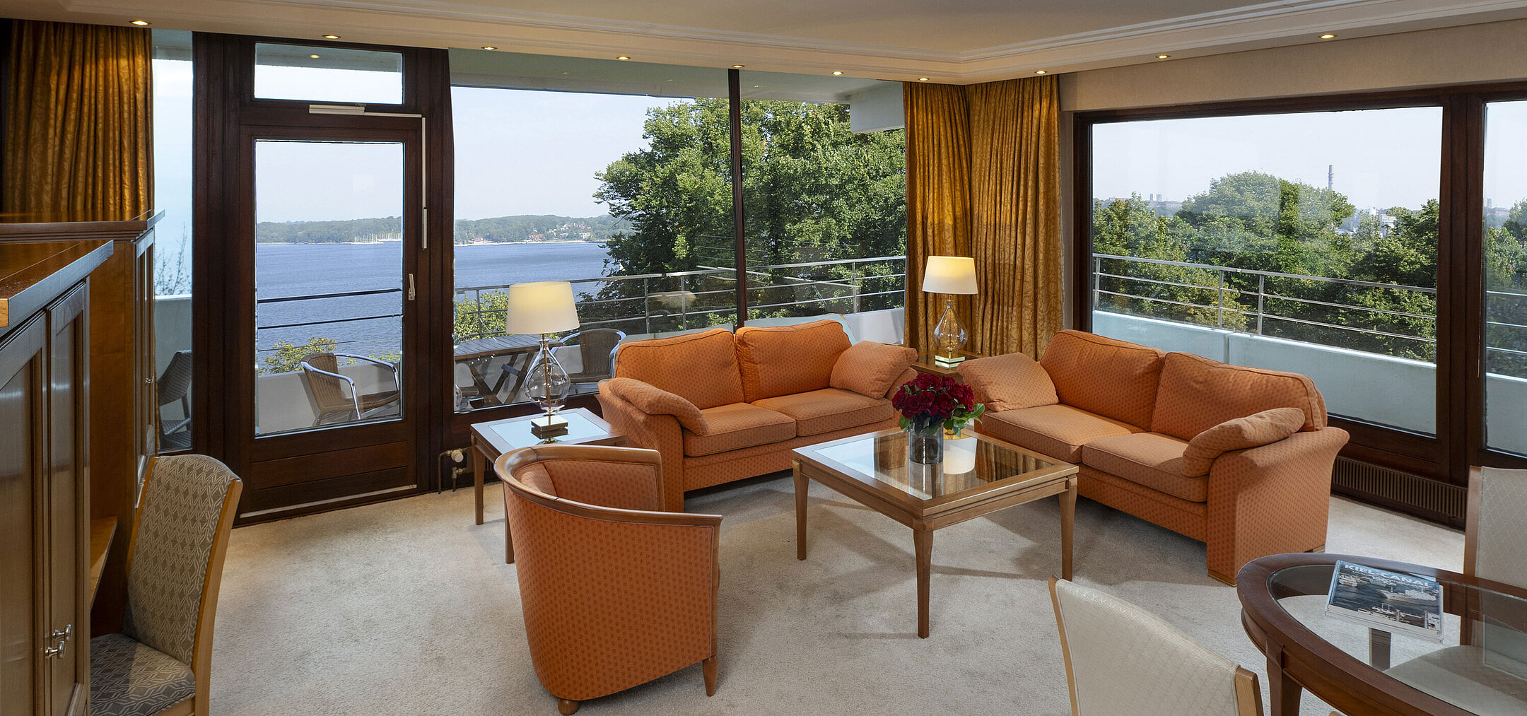 Bright living area of the presidential suite at Maritim Hotel Kiel with panoramic Baltic Sea view and stylish furniture.