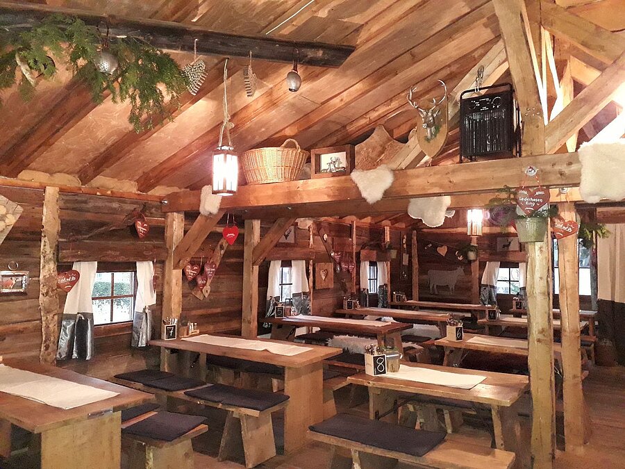 Cosy dining room with wooden tables and alpine decor at Maritim Alm next to Maritim Hotel Stuttgart