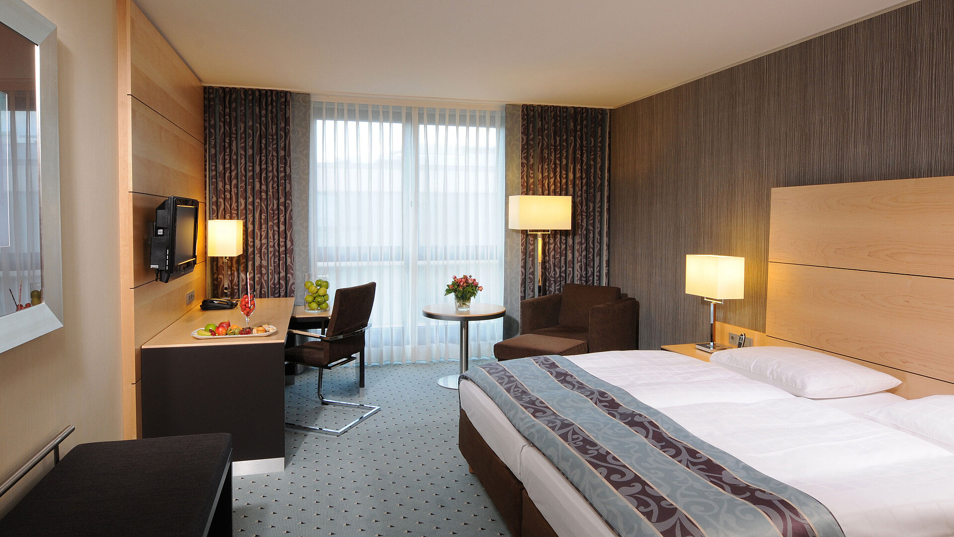 Superior room at Maritim Hotel Düsseldorf with stylish double bed, modern desk, cozy seating area, and fresh details.