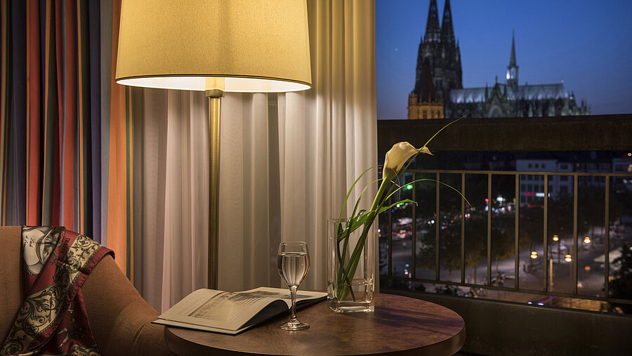 Superior room at Maritim Hotel Cologne at night with a romantic view of the illuminated Cologne Cathedral.