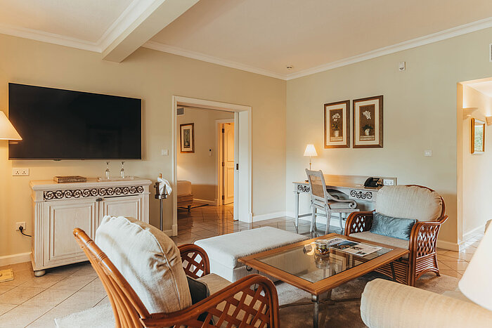 Penthouse Suite Spacious living area of the Penthouse Suite with seating area, dining table and elegant furnishings.