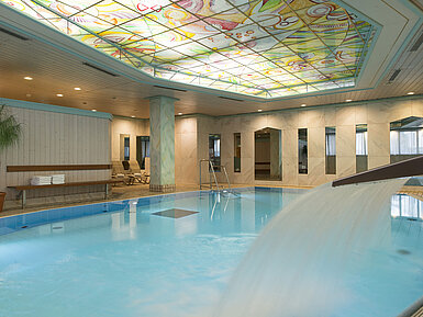 Swimming pool Heated indoor pool with waterfall and colourful glass ceiling at the Maritim Hotel Stuttgart