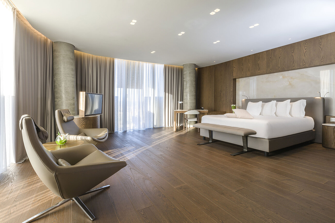 Spacious room with panoramic windows, armchairs and modern design at Maritim Hotel Plaza Tirana