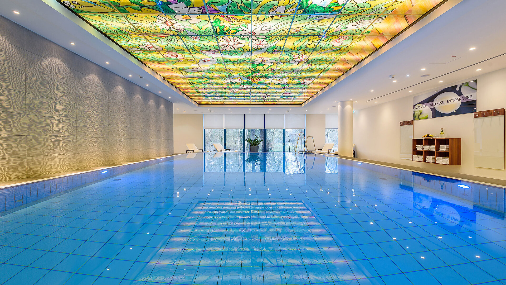 Elegant pool area at Maritim Hotel Bremen with colorful glass ceiling and modern lighting,perfect for wellness and relaxation