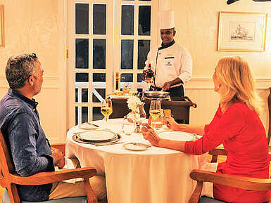 Dining Couple enjoying an exclusive dinner with live cooking at the table