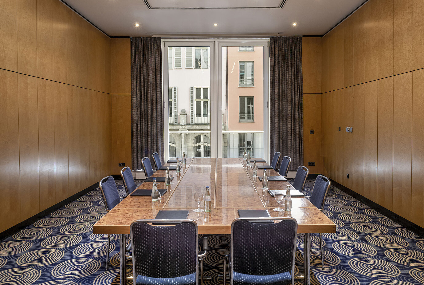 Salle de réunion lumineuse Salon I à l'Hôtel Maritim proArte Berlin avec grande table de conférence et vue sur l'extérieur.