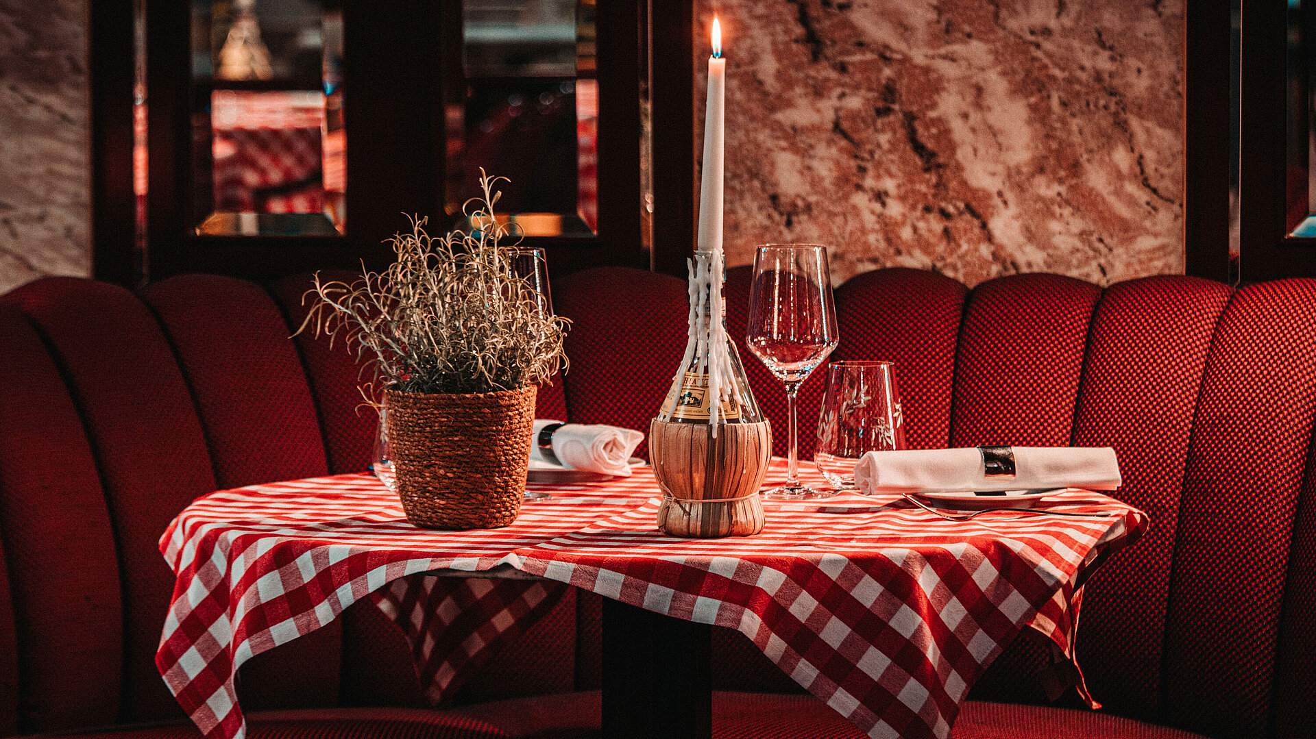 Brasserie Restaurant  Romantic table setting with candle and checkered tablecloth in restaurant