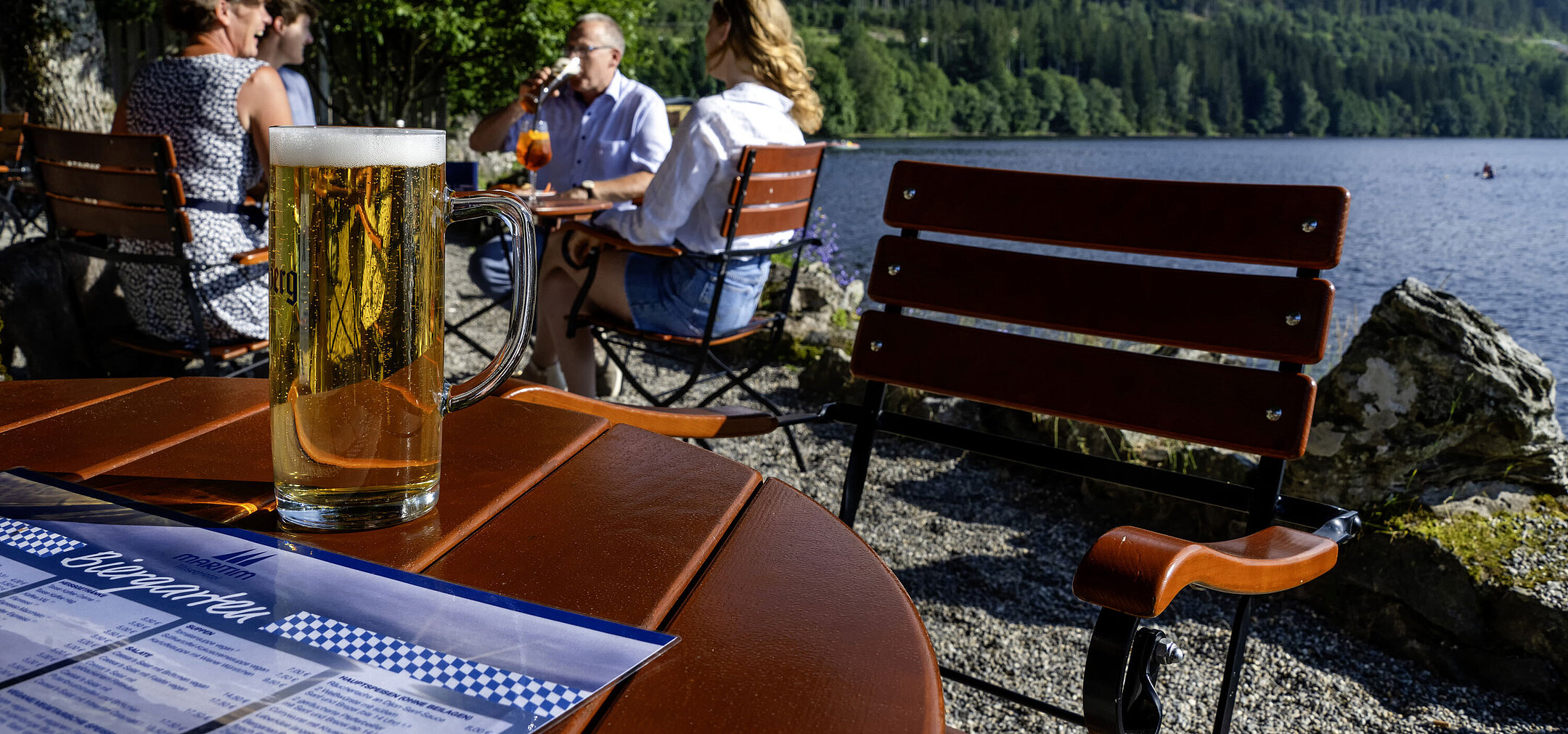 Beer garden Fresh beer on the table in the beer garden of Maritim Hotel Titisee by the lake shore